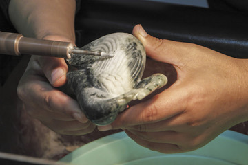 Worker grinding sculpture in jade at factory, Xian, China © William