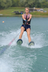 Fototapeta premium young woman water skiing on a sea
