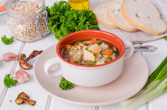 Vegan soup with pearl barley, vegetables and mushrooms