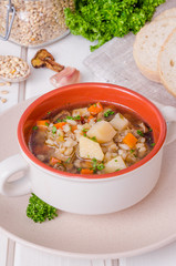 Vegan soup with pearl barley, vegetables and mushrooms