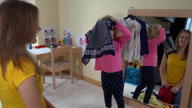 Woman with toddler girl have fun at home