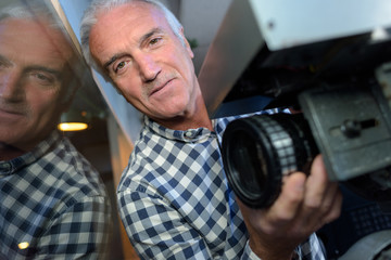 mature professional fillm technician working