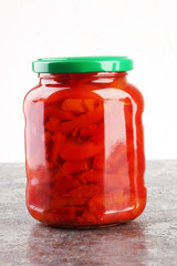 Jar with variety of pickled vegetables. Carrots, field garlic, c