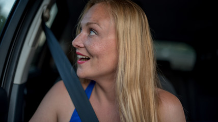 Fototapeta na wymiar Attractive blonde girl in the car