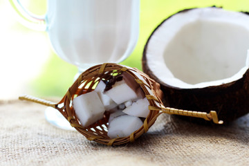 Coconut and coconut milk in glass on nature background