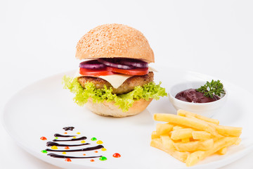 burger sauce and french fries on a  round  white plate