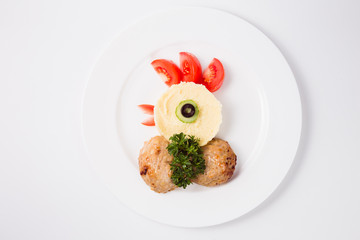 Children's complex lunch like a rooster (mashed potatoes, cutlet, vegetables).  Top view