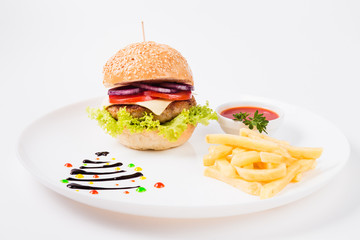 burger sauce and french fries on a  round  white plate