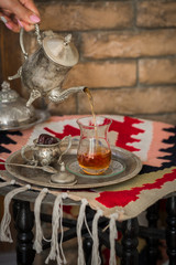Fototapeta premium Tea set in oriental style in pear shaped glass with vintage kettle and dates fruit