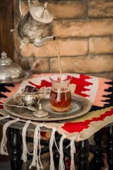 Tea set in oriental style in pear shaped glass with vintage kettle and dates fruit