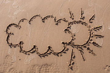 sun with cloud drawing on beach sand