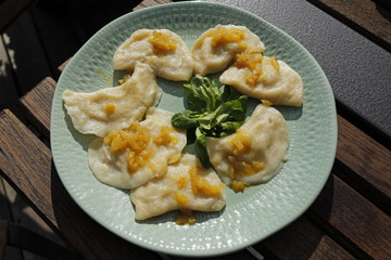 russian dumplings (pierogi, pelmeni) with onion and butter