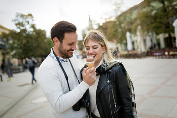 Romantic young attractive couple sharing ice cream