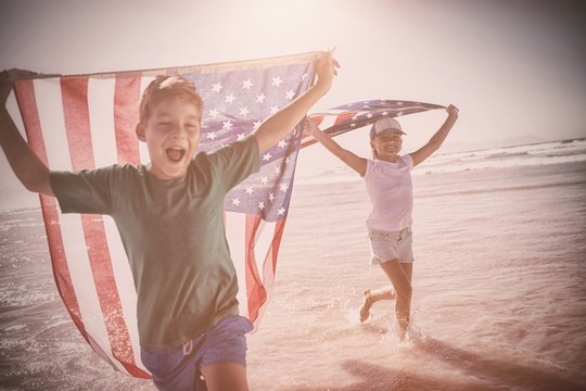 Happy children taking an american flag - Powered by Adobe