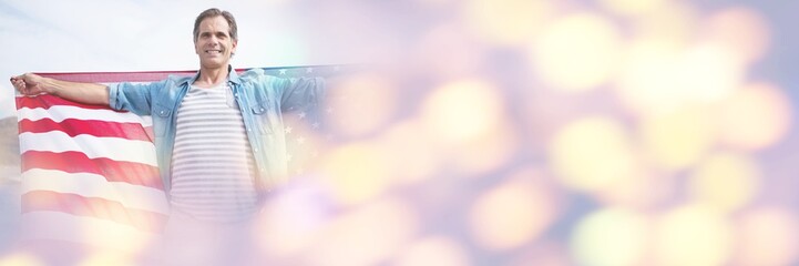 Man holding american flag at beach