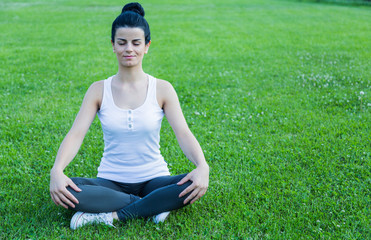 Young girl doing yoga in the Park