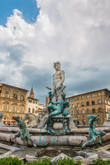 Fototapeta na wymiar Fountain Neptune in Piazza della Signoria in Florence, Italy. Florence famous fountain. Florence architecture. One of the main landmarks in Florence.