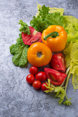 Fresh red and yellow tomatoes, sweet pepper and lettuce