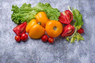 Fresh red and yellow tomatoes, sweet pepper and lettuce