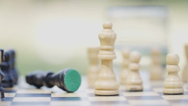 Close up shot of a winning move in chess, in slow motion 