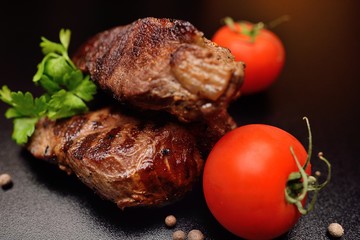Steak from beef sous vide closeup on a dark background