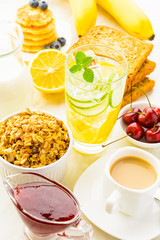 Healthy breakfast with detox water, granola, berries and fruits