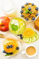 Breakfast with cottage cheese pancakes, granola, detox water, coffe and fruites