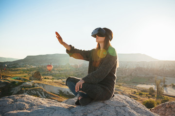 Naklejka na ściany i meble Woman with glasses of virtual reality. Future technology concept. Modern imaging technology.