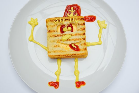 Sandwich in the form of Sponge Bob with cheese, ham and ketchup on a white background