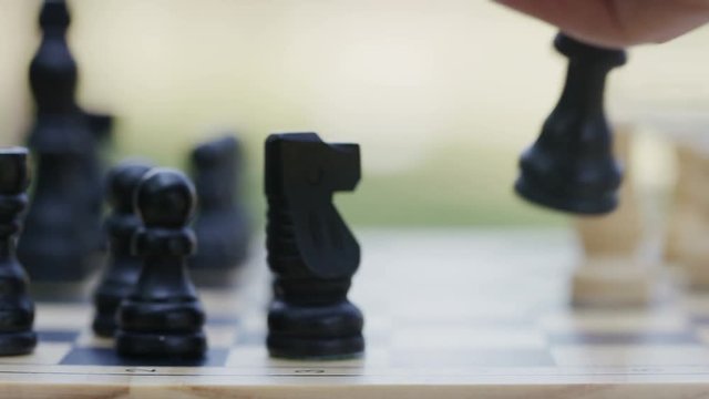 Close up of hands playing chess, in slow motion