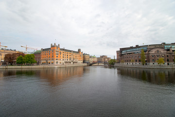 Stockholm, the capital of Sweden. The parliament building on the right side and the Goverment Office on the left side of the channel.