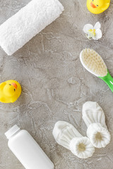 cosmetics for baby bath, towel and toys on gray background top view space for text