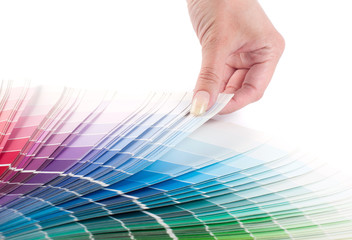 The person chooses a color in the palette for paint tinting. Colored catalog fan. The concept of...