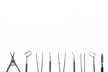 teeth care with dentist instruments in doctor's office white background top view mock-up