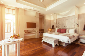 Fototapeta na wymiar Luxury bedroom hotel interior, big window, TV on white wall, fruits on the table