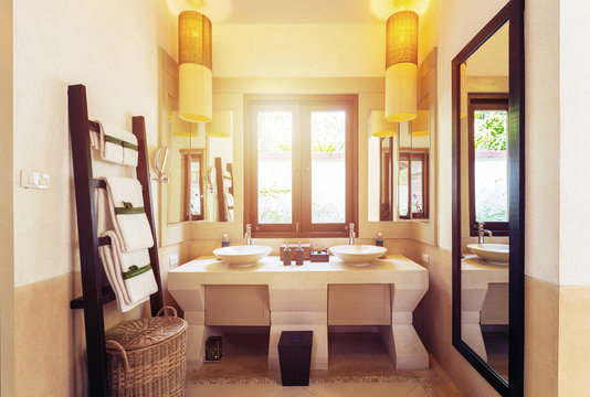 Interior of bathroom with washbasin faucet and white towels. Modern bathroom  design