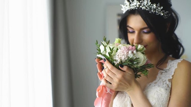 beautiful bride smelling wedding bouquet