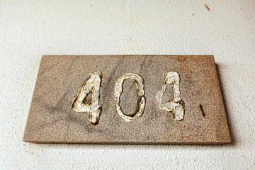 Error 404 number plate in abandoned building on the old wall