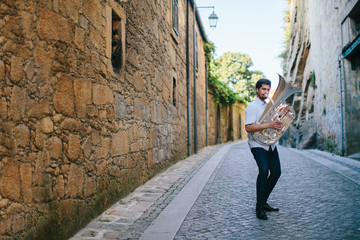 Street musician playing tuba outdoor in European city