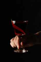 Glass of red moon in the hands. Close up
