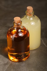 Two bottles of alcohol on the black table. Close up