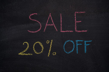 Sale 20% off. Sale and discount price sign drawn with chalk on blackboard