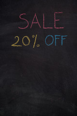 Sale 20% off. Sale and discount price sign with copyspace drawn with chalk on blackboard
