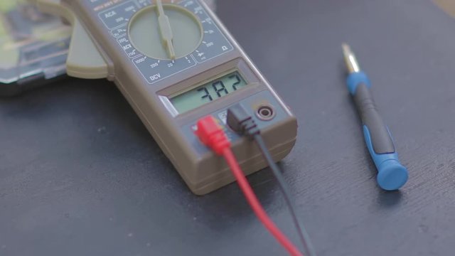 Multimeter showing different values on its screen.