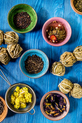 Tea-party with different herbal tea on blue desk background flat lay pattern