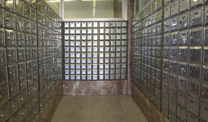 Room full of rows of metal post office boxes