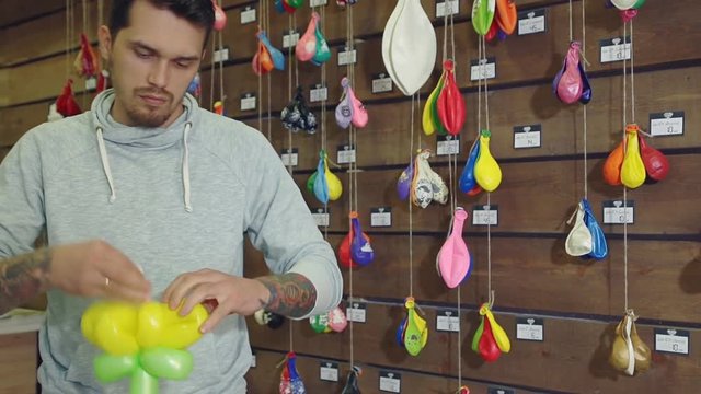 Man Amusing Children With Making Balloon Figures. Making Baloon Flower.