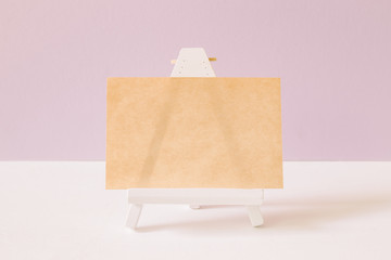 Empty paper on white painted wooden easel