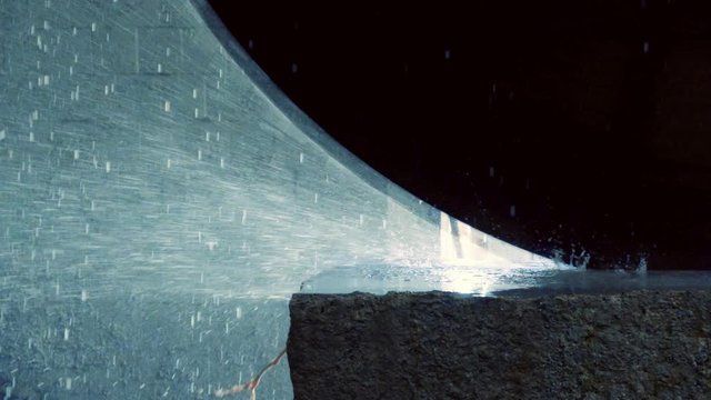 Sprays in slow motion fly from under a circular saw cutting a stone block