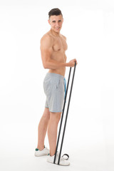 Muscular young sportsman exercising on white background